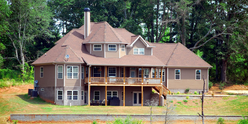 large 3-story victorian home with wooded backyard