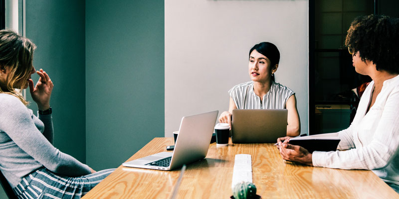 3 women at conference room table