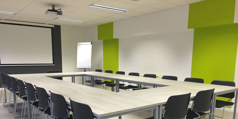 black chairs and white table in office presentation room