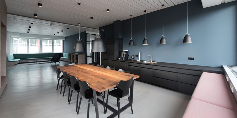 modern office kitchen with cool accents and aesthetics and wooden table