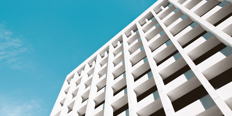 white commercial building with clear skies