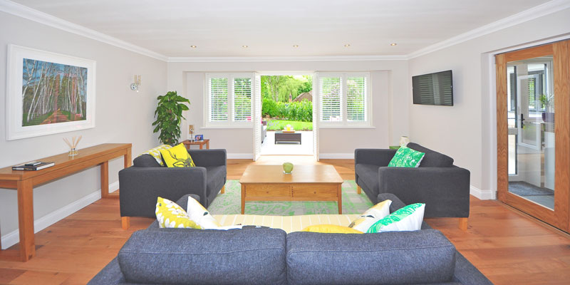 vivid-colored home living room with 3 love seats during daytime