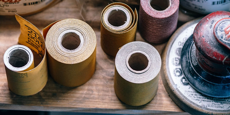 rolls of sand papaer on workshop table