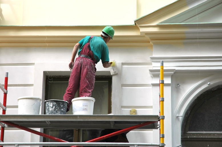 professional painter painting the exterior of a house