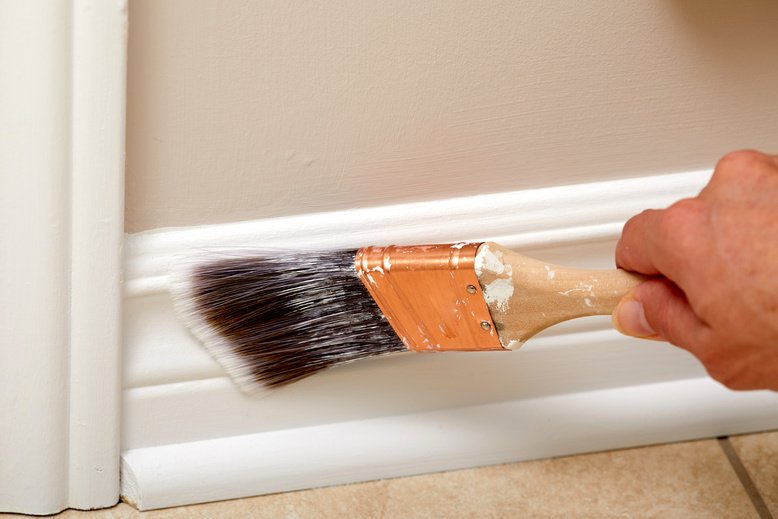professional painter painting trim in house
