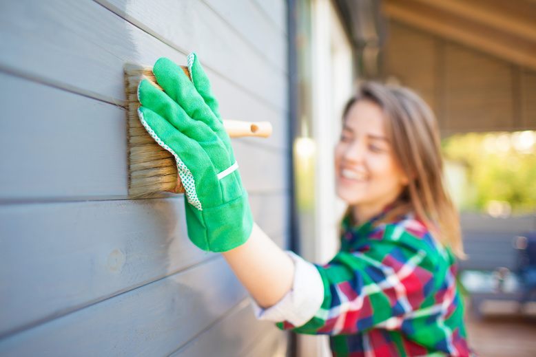 homeowner painting house exterior