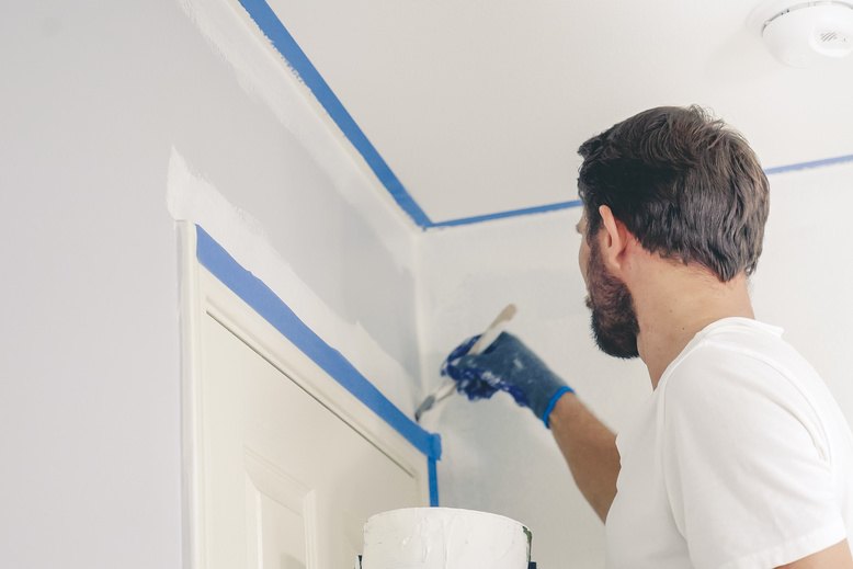 professional painter painting above interior door